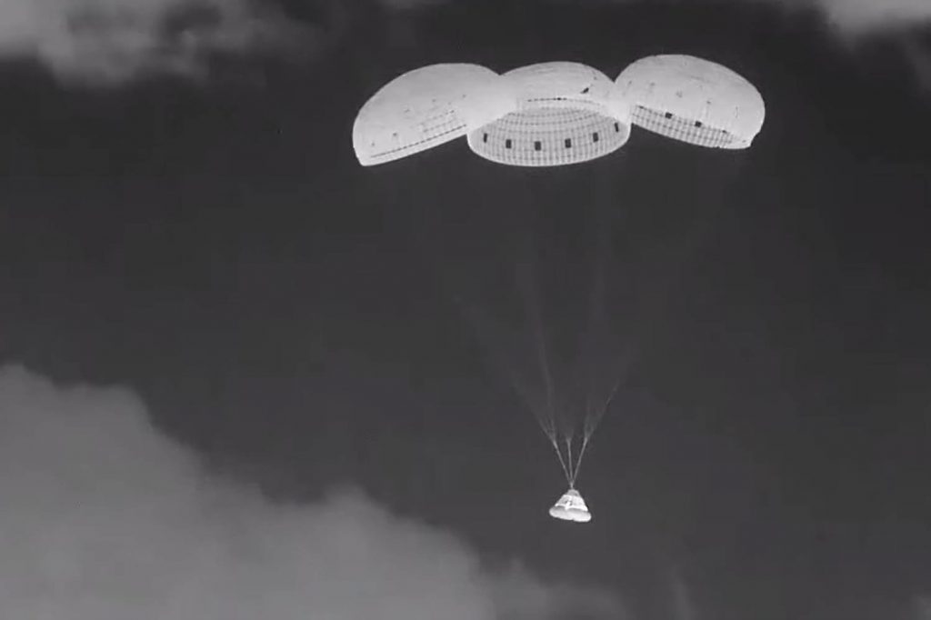 Two astronauts watch their spacecraft return without them on it