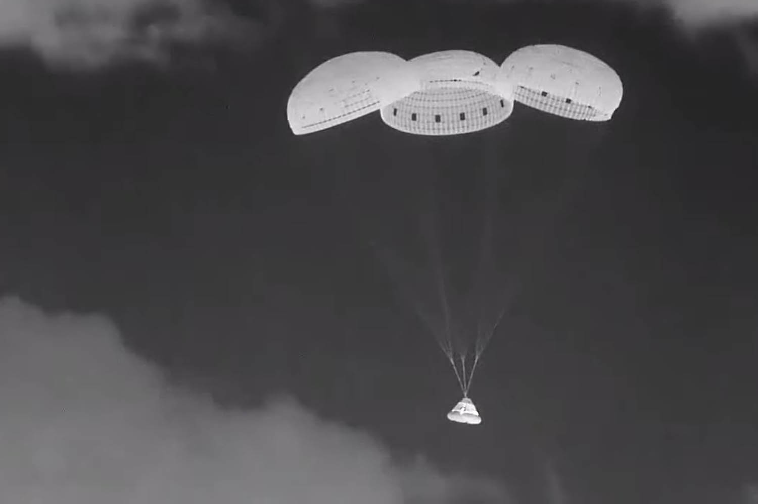 Two astronauts watch their spacecraft return without them on it